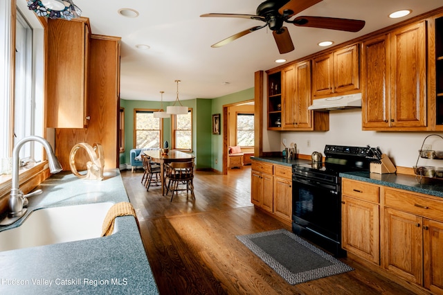 kitchen featuring ceiling fan, sink, dark wood-type flooring, black electric range, and decorative light fixtures