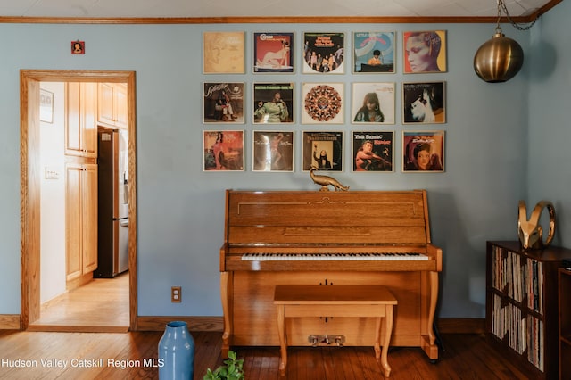 miscellaneous room featuring hardwood / wood-style flooring and ornamental molding