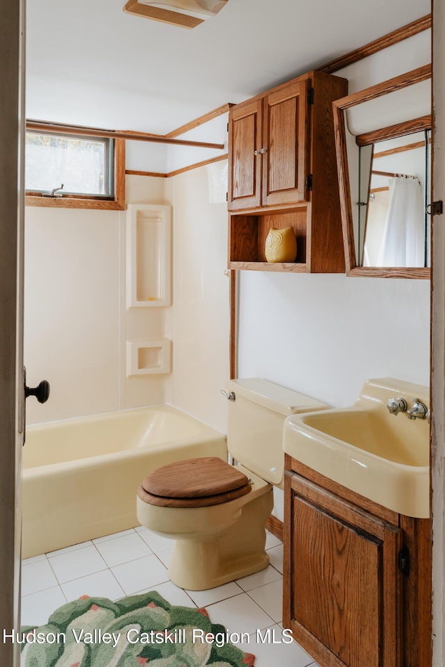 full bathroom featuring tile patterned flooring, vanity, toilet, and shower / bathtub combination with curtain