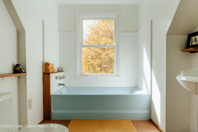 bathroom featuring a tub to relax in