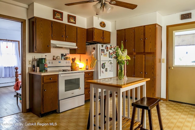 kitchen featuring under cabinet range hood, light floors, a ceiling fan, and white appliances