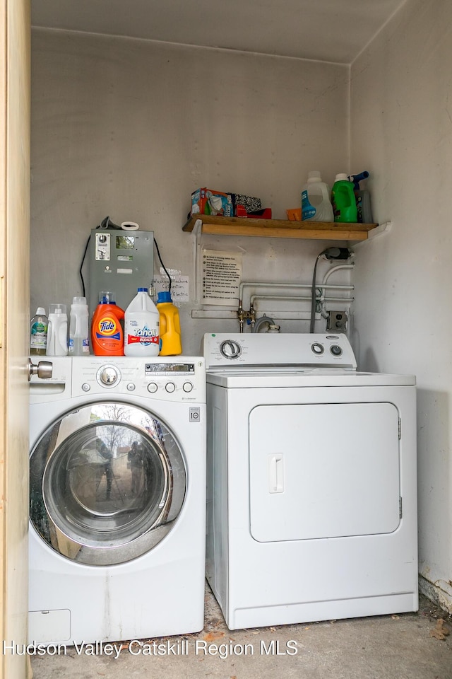clothes washing area featuring washer and dryer and laundry area