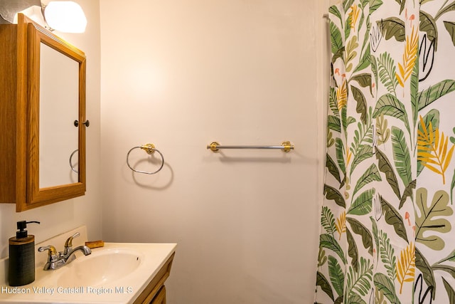 bathroom with curtained shower and vanity