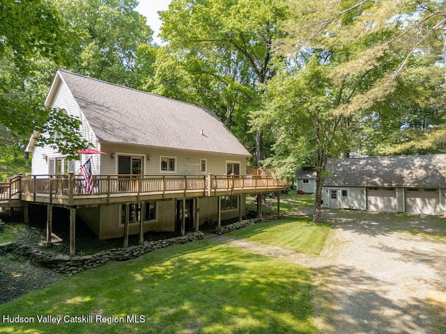 53 Snyder Pond Rd, Copake, NY 12516 - back of property featuring a wooden deck, a shingled roof, a yard, an outbuilding, and a detached garage