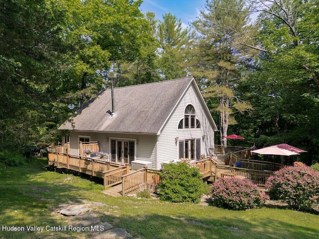 53 Snyder Pond Rd, Copake, NY 12516 - back of property with french doors, a wooden deck, a yard, a shingled roof, and view of scattered trees