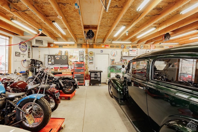 53 Snyder Pond Rd, Copake, NY 12516 - garage with a workshop area and a wall mounted AC
