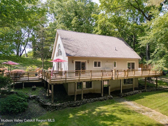 53 Snyder Pond Rd, Copake, NY 12516 - back of property featuring a deck, a lawn, a shingled roof, and view of wooded area