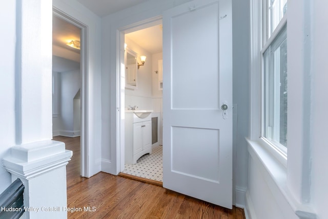 corridor with hardwood / wood-style flooring