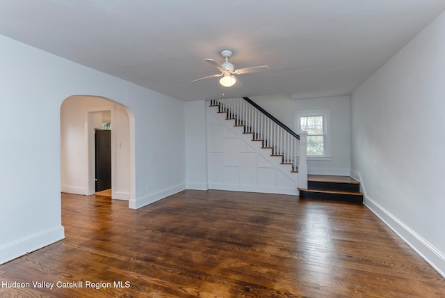 empty room with dark hardwood / wood-style floors and ceiling fan