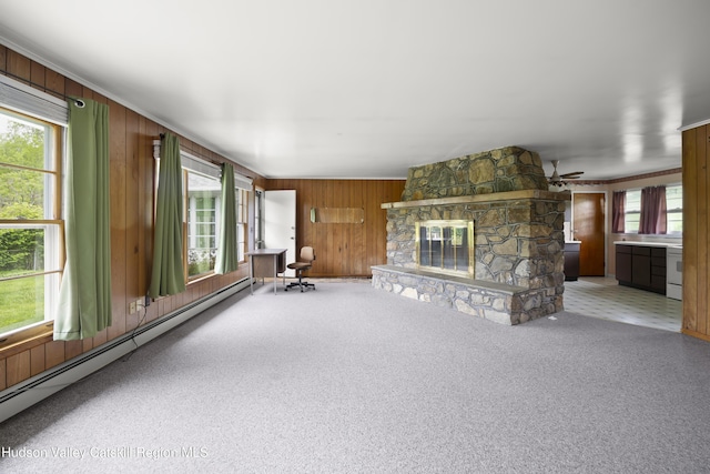 118 Yonderview Rd, Hillsdale, NY 12529 - unfurnished living room featuring baseboard heating, wooden walls, carpet flooring, a fireplace, and ceiling fan