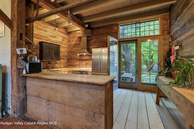 16-26 Shultis Brook Rd, Bearsville, NY 12409 - kitchen with wooden walls, exhaust hood, light countertops, a peninsula, and high end fridge