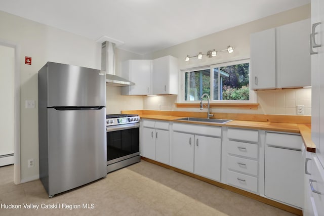 16-26 Shultis Brook Rd, Bearsville, NY 12409 - kitchen with stainless steel appliances, wall chimney exhaust hood, decorative backsplash, white cabinets, and baseboard heating