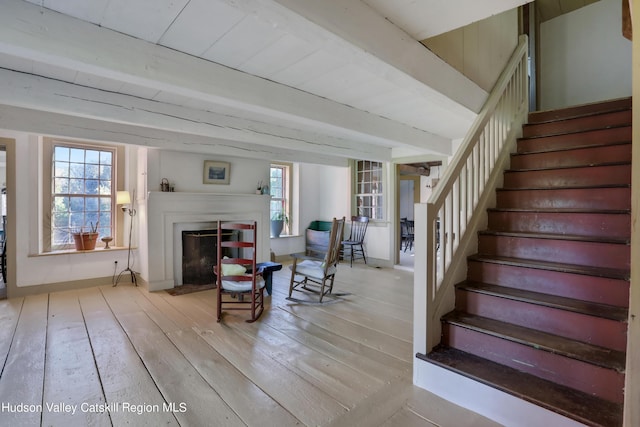 16-26 Shultis Brook Rd, Bearsville, NY 12409 - stairway with wood-type flooring, a fireplace with flush hearth, healthy amount of natural light, and beamed ceiling
