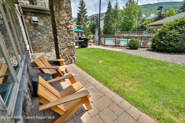 10 Enclave N Dr Unit 106, Windham, NY 12496 - view of yard featuring a community pool, a patio, and a mountain view