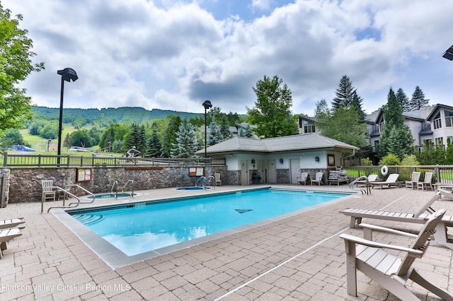 10 Enclave N Dr Unit 106, Windham, NY 12496 - community pool with a patio area, a community hot tub, and a mountain view