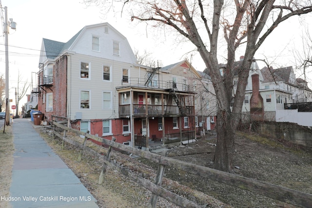 rear view of property featuring a balcony