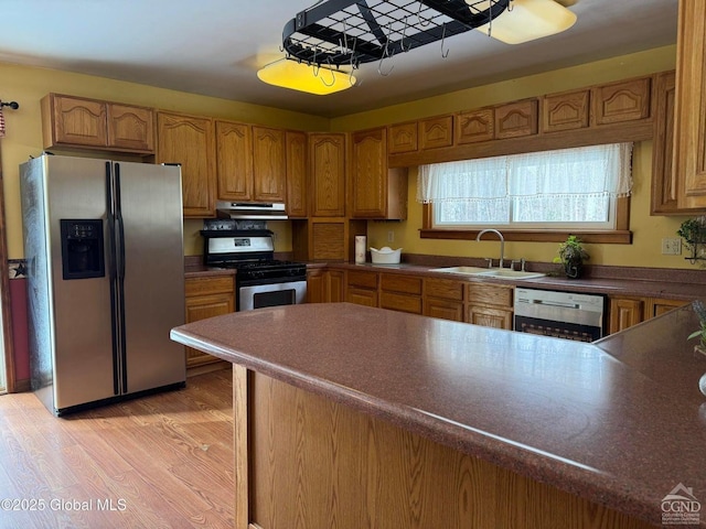 317 Scutt Rd, Greenville, NY 12083 - kitchen featuring appliances with stainless steel finishes, a sink, brown cabinets, and light wood-style floors
