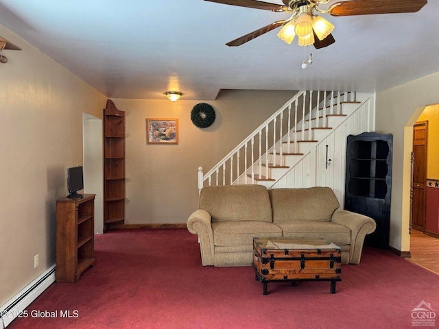 317 Scutt Rd, Greenville, NY 12083 - living room featuring a baseboard heating unit, carpet floors, a ceiling fan, stairway, and arched walkways