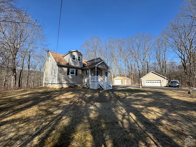 317 Scutt Rd, Greenville, NY 12083 - view of front of property with an outbuilding, covered porch, and a detached garage