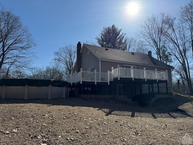 317 Scutt Rd, Greenville, NY 12083 - back of property featuring a chimney, a wooden deck, and a covered pool