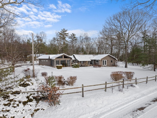 view of snow covered rear of property