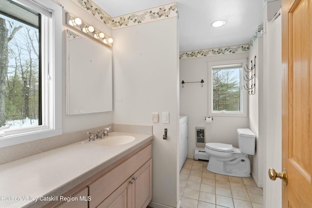 bathroom featuring vanity, tile patterned floors, baseboard heating, and toilet