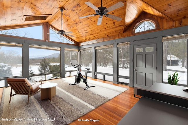 sunroom featuring lofted ceiling, a mountain view, and wooden ceiling