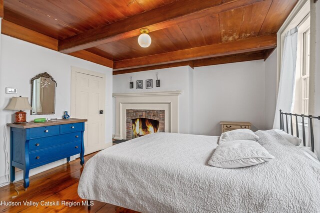 5868 Rte 209, Rochester, NY 12446 - bedroom with a wood ceiling with exposed beams, wood finished floors, and a lit fireplace