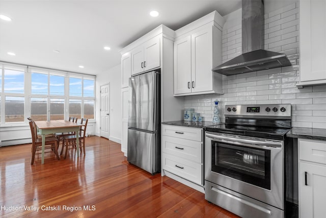 5868 Rte 209, Rochester, NY 12446 - kitchen featuring wall chimney exhaust hood, appliances with stainless steel finishes, decorative backsplash, dark wood-type flooring, and recessed lighting
