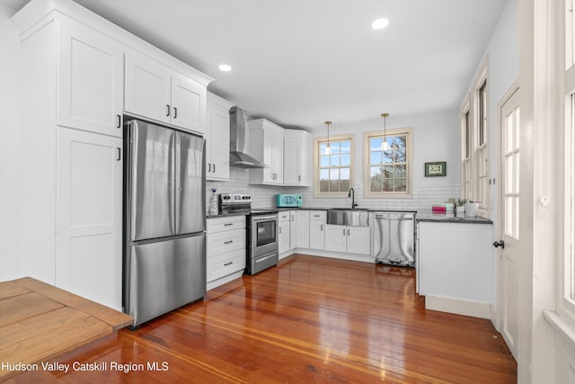5868 Rte 209, Rochester, NY 12446 - kitchen with stainless steel appliances, wall chimney exhaust hood, tasteful backsplash, dark wood-type flooring, and white cabinets