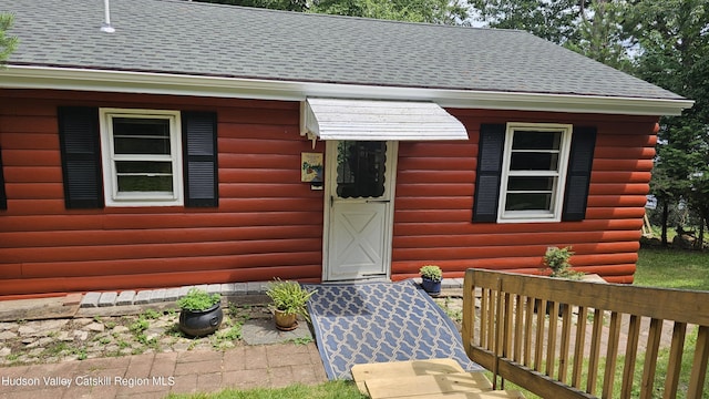 192 W Shore Dr, Valatie, NY 12184 - view of exterior entry featuring a shingled roof and log veneer siding