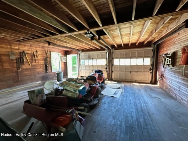 garage featuring wood walls