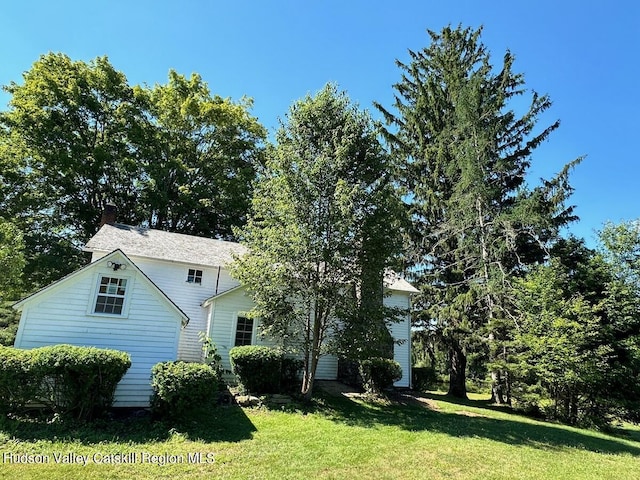 view of side of home featuring a lawn