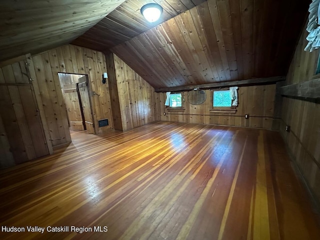 bonus room with lofted ceiling, wood-type flooring, wooden walls, and wooden ceiling