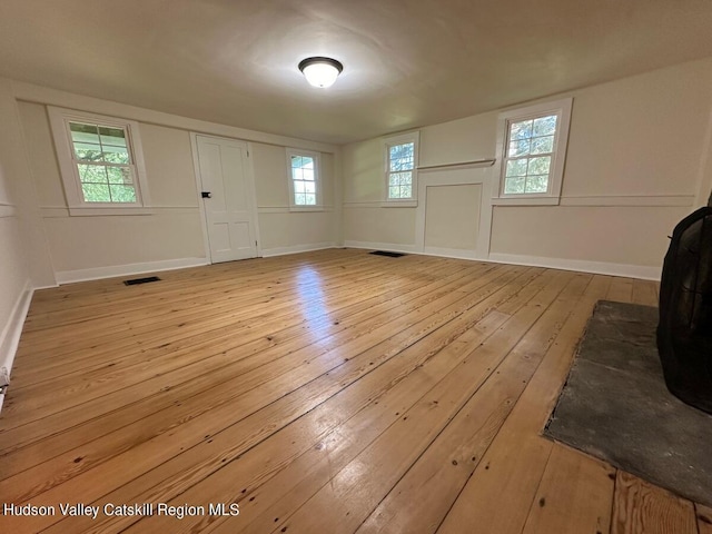 entrance foyer with light hardwood / wood-style flooring and a healthy amount of sunlight