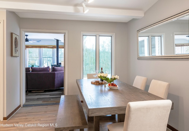 dining room featuring beamed ceiling and hardwood / wood-style floors