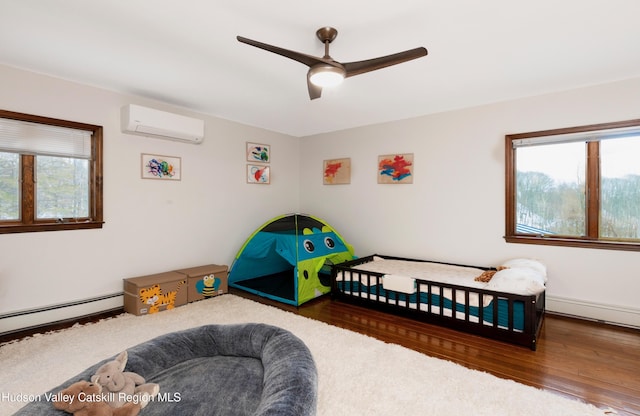 bedroom with dark hardwood / wood-style flooring, ceiling fan, a wall mounted AC, and baseboard heating