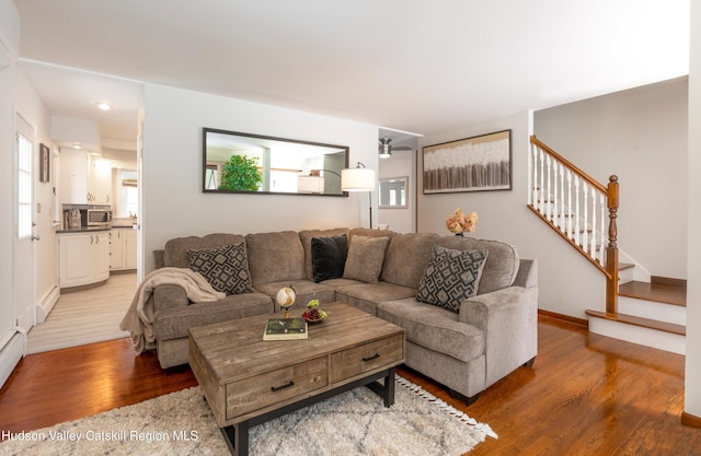 living room featuring hardwood / wood-style floors and a baseboard heating unit