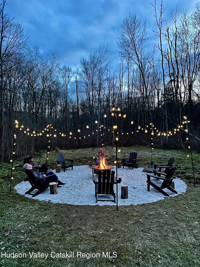 yard at dusk with a fire pit