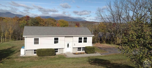 1316 Woods Rd, Germantown, NY 12526 - bi-level home featuring a front yard, a wooded view, and a mountain view