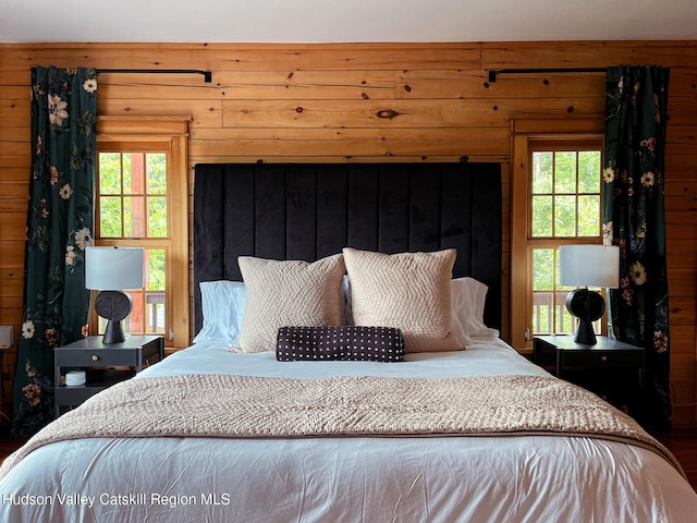 60 Leon Ln, Stony Creek, NY 12878 - bedroom with multiple windows, wooden walls, and wood finished floors