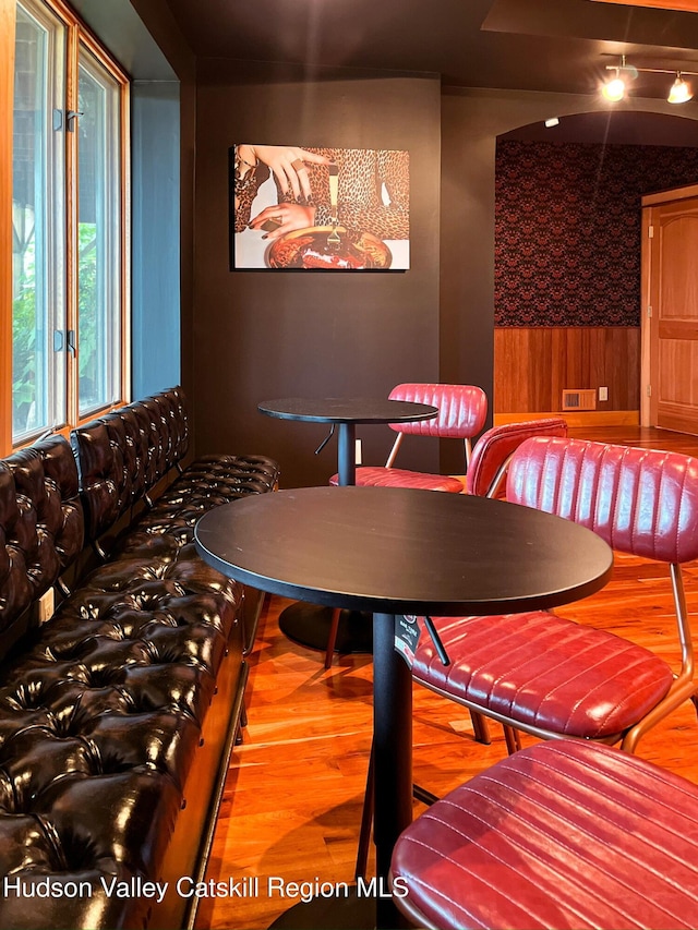 60 Leon Ln, Stony Creek, NY 12878 - dining area with wood finished floors, wallpapered walls, and a wainscoted wall