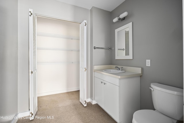 244 Columbia St, Hudson, NY 12534 - bathroom with vanity, toilet, a closet, and baseboards