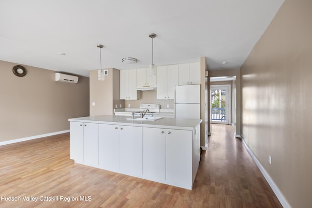 244 Columbia St, Hudson, NY 12534 - kitchen featuring freestanding refrigerator, a wall mounted AC, light wood finished floors, and baseboards