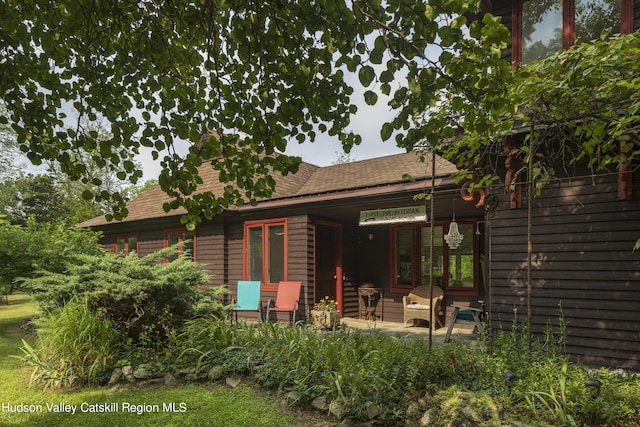 rear view of property featuring a patio area