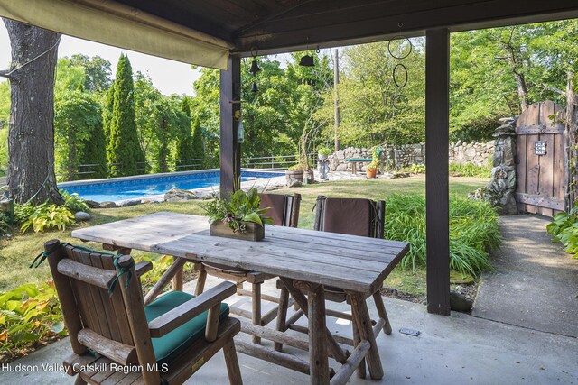 159 Sawmill Rd, Milan, NY 12571 - view of patio / terrace featuring outdoor dining space, an outdoor pool, and view of wooded area
