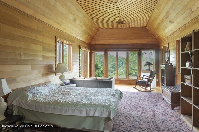 bedroom featuring lofted ceiling, wooden walls, and wooden ceiling