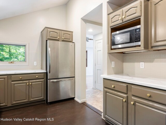 221 Cardinal Rd, Hyde Park, NY 12538 - kitchen featuring stainless steel appliances, gray cabinetry, backsplash, dark wood-style floors, and ceiling fan