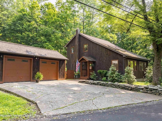 221 Cardinal Rd, Hyde Park, NY 12538 - rustic home with a chimney, an outdoor structure, a garage, and roof with shingles
