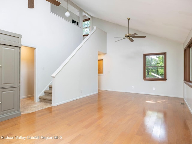 221 Cardinal Rd, Hyde Park, NY 12538 - unfurnished living room featuring ceiling fan, stairway, light wood-type flooring, and high vaulted ceiling